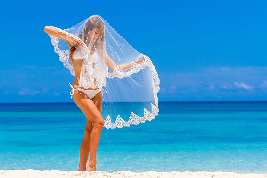 Woman on beach in white bikini