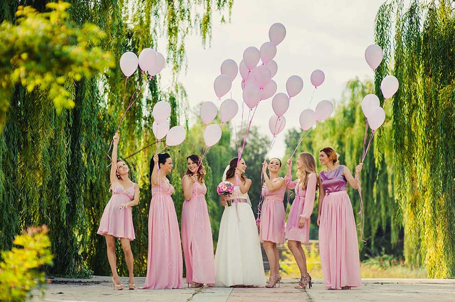 Photo of bridal party holding balloons